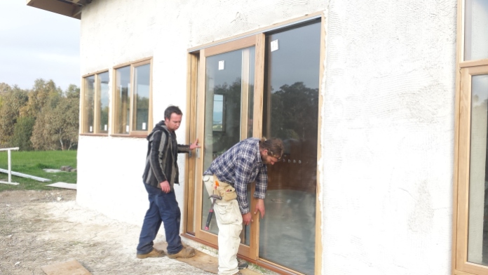 Cam and Matty mounting the front door